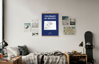 Room interior with a Colorado ski resorts poster on the wall, surrounded by snowboard and bed