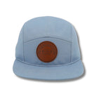 McSenderson light blue 5-panel camper hat with a brown leather patch featuring ski goggles.